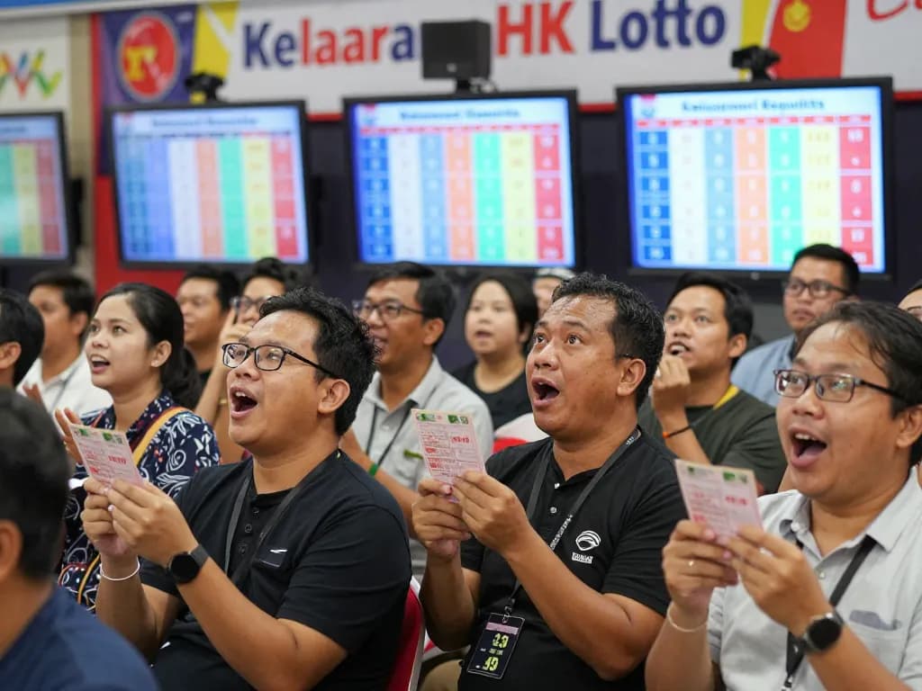 Enthusiastic crowd eagerly watching Data HK results during live Keluaran HK Lotto event with bright screens.